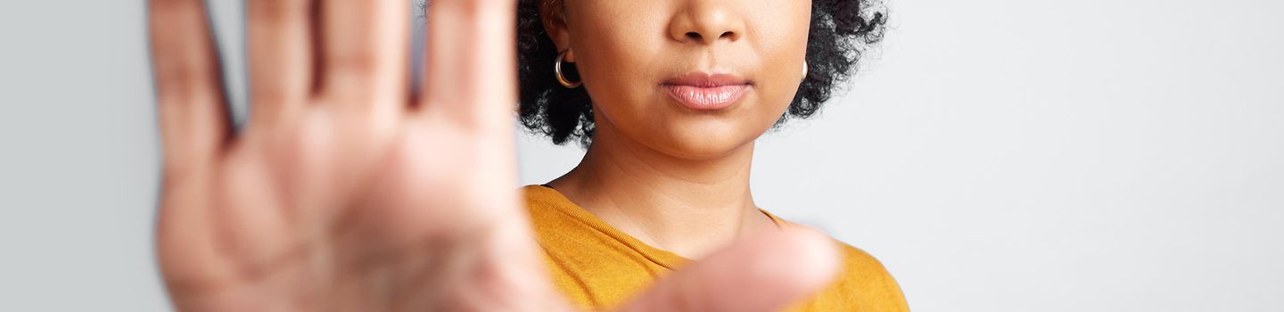 Eine junge Frau hält ihre ausgestreckte Hand der Kamera entgegen.